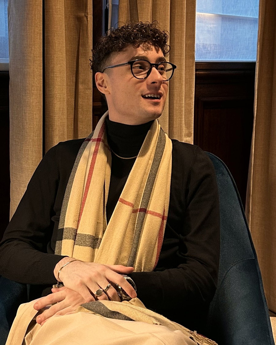 Jack, the founder of Crosspoint Collective, sitting in an armchair mid-conversation.